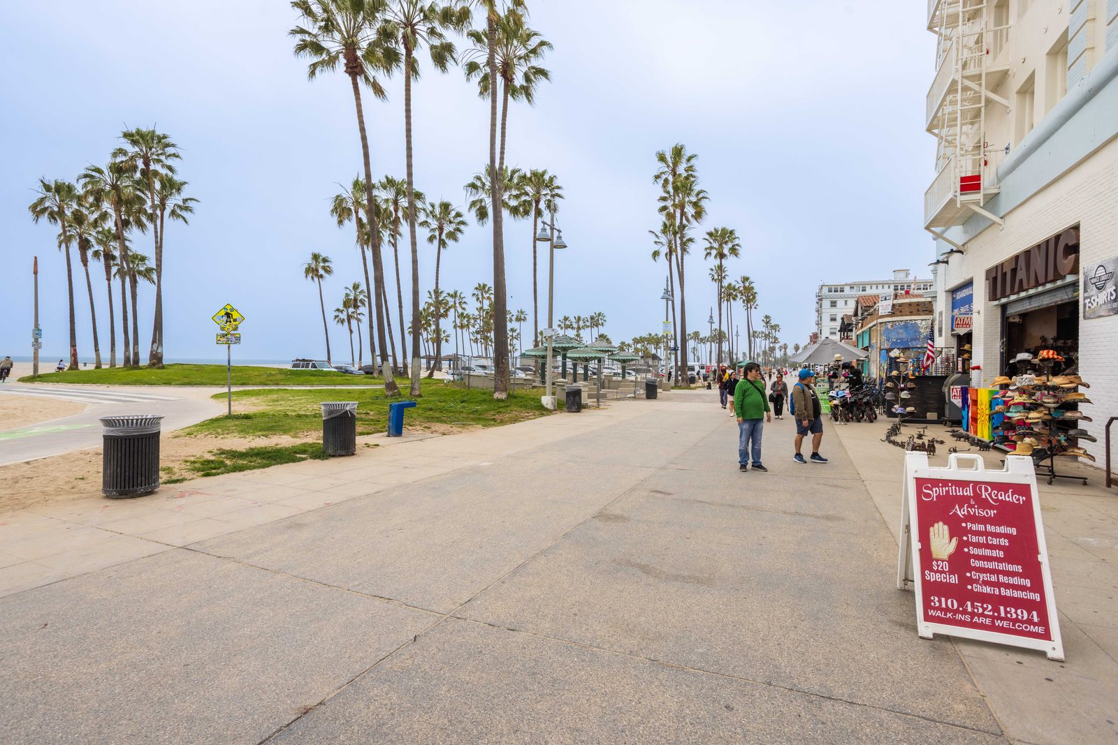 Venice boardwalk, palm-lined, steps from the Stay